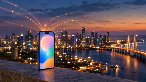 Smartphone showing a colourful app screen against the Mumbai skyline at dusk